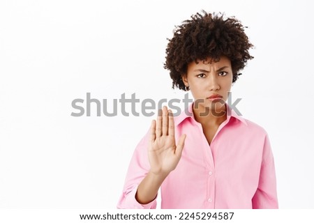 Angry businesswoman shows stop, prohibition gesture, makes no sign, refusing smth bad