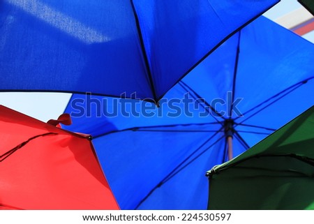 many bright vivid umbrellas hanging in street London