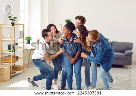 Haha, hahaha. Happy multiracial friends having fun at a party at home. Group of cheerful joyful young diverse people laughing at a very funny joke their friend has told Royalty-Free Stock Photo #2245307581