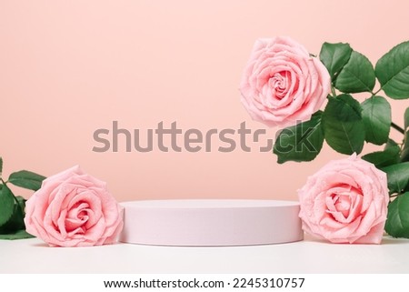 Blank podium with pink roses on pink background. Showcase for product, perfume, jewelry and cosmetic presentation Royalty-Free Stock Photo #2245310757