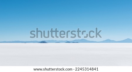 Panorama of lost islands in a sea of salt, Uyuni salt flat desert, Bolivia. Royalty-Free Stock Photo #2245314841