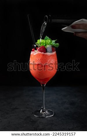 Delicious Spanish food, dishes on a dark background in a restaurant, tasty-looking dishes and drinks, colorful drink with fruit Royalty-Free Stock Photo #2245319157