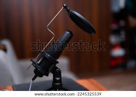 close-up of a studio microphone with a pop filter. Recording a podcast