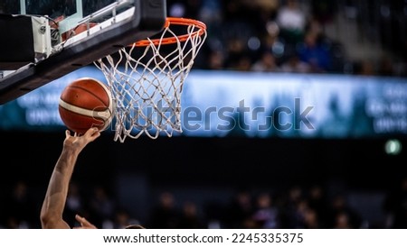 basketball game ball in hoop Royalty-Free Stock Photo #2245335375