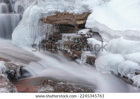 Frozen waterfall. Winter landscape with water frozen cascades Royalty-Free Stock Photo #2245345761