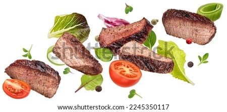 Falling steak salad ingredients isolated on white background, sliced beefsteak, food packaging concept Royalty-Free Stock Photo #2245350117