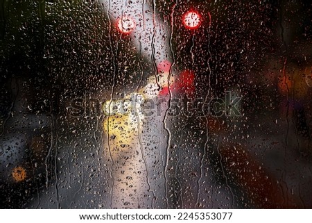 Raindrops on bus window and lights