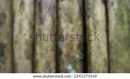 blurred mossy bamboo fence as background