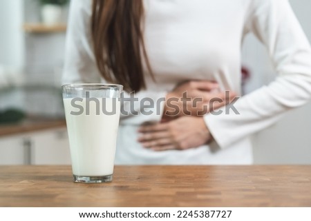 lactose intolerance concept. Woman having a stomach ache from lactose intolerance. Royalty-Free Stock Photo #2245387727