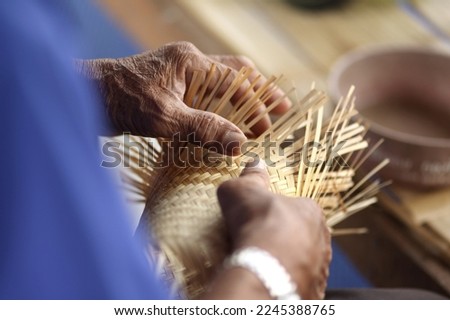 handmade crafts of wicker craftsmen Bamboo wicker products. Thai products from woven bamboo into containers for storing various items. Royalty-Free Stock Photo #2245388765