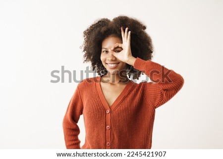 Portrait of African American young woman smiling raise hand gesture okay, done, deal looking toward camera