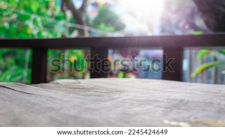 Empty wooden table with lights bokeh on blur nature background, table wood for product display template