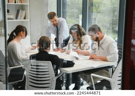 Corporate business team and in a meeting at modern office with big windows . High quality photo.