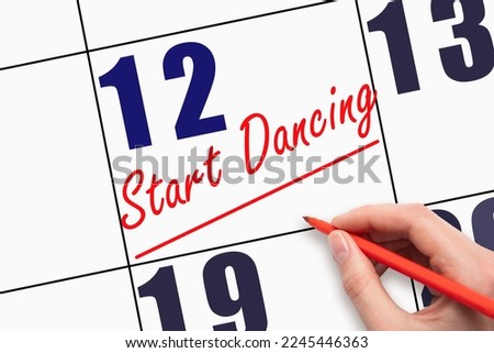 12th day of the month. Hand writing text START DANCING and drawing a line on calendar date. Save the date. Deadline. Business concept Day of the year concept.