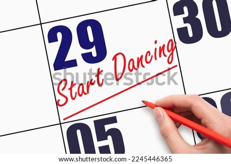 29th day of the month. Hand writing text START DANCING and drawing a line on calendar date. Save the date. Deadline. Business concept Day of the year concept.