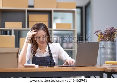 Young Asian business entrepreneur stress in online business, failure woman with working problem. SME entrepreneur and Online selling concept. Royalty-Free Stock Photo #2245452943