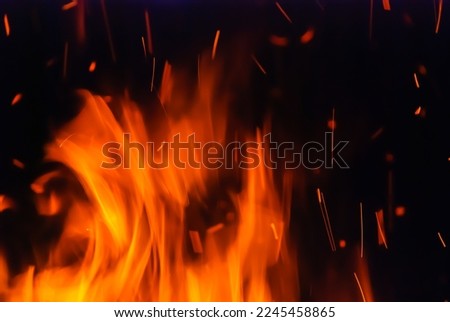 Abstract blaze fire flame texture for banner background. Fire sparks particles with flames isolated on black background. Beautiful flames. Fuel, power and energy.