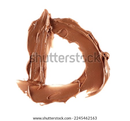 Cream chocolate spreading in shape letter D, alphabet isolated on white, clipping path, top view