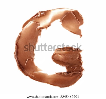 Cream chocolate spreading in shape letter G, alphabet isolated on white, clipping path, top view