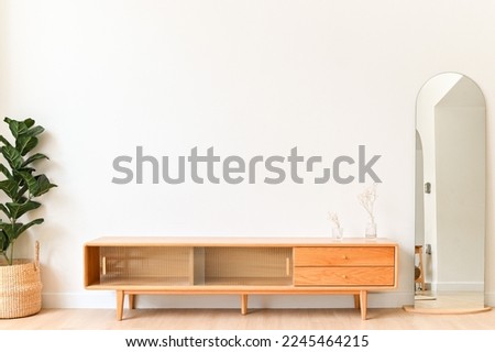 White color wall Background, minimal living room interior decor with a TV cabinet. Royalty-Free Stock Photo #2245464215