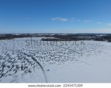Snow-swept frozen lake after a storm