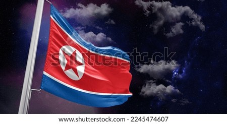 Korea, North national flag cloth fabric waving on beautiful Blue Background.