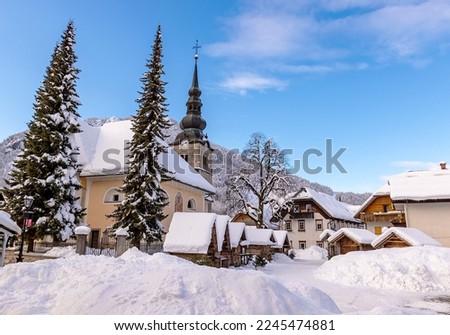 Winter landscape of Kranjska Gora village center with church and Christmas markets, Slovenia Royalty-Free Stock Photo #2245474881