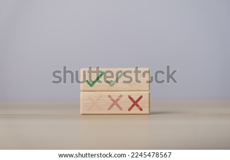Wooden blocks show checks marks and are wrong. concepts decisions, votes, and thinking yes or no. Business options for difficult situations true and false symbols