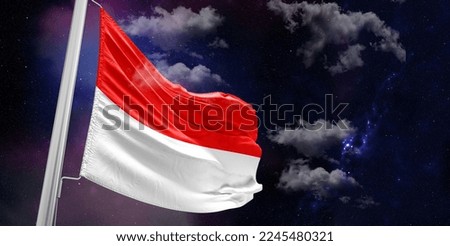Indonesia national flag cloth fabric waving on beautiful Blue Background.