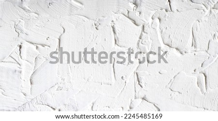 White wall putty texture, rough grunge close-up background in banner or panorama format. Gypsum texture. Royalty-Free Stock Photo #2245485169