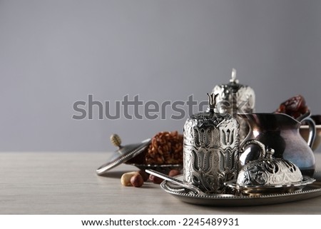 Tea, date fruits and Turkish delight served in vintage tea set on wooden table, space for text