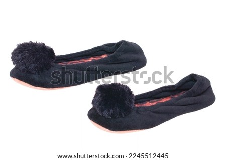 Slippers isolated. Close-up of a pair of black female house slippers isolated on a white background. Woman shoes.