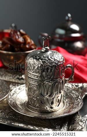 Tea and date fruits served in vintage tea set on table, closeup