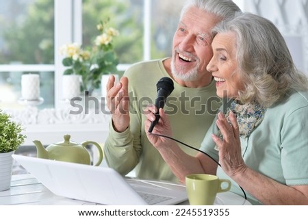 senior couple husband and wife singing songs Royalty-Free Stock Photo #2245519355