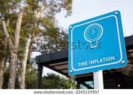 Blue tire inflating sign in gas station