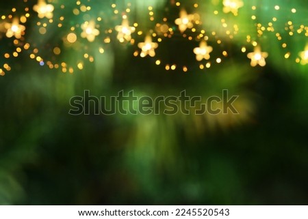 Abstract party background, blurred leaves and bright lights