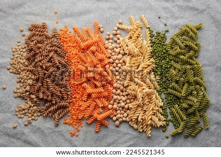 A variety of fusilli pasta made from different types of legumes, green and red lentils, mung beans and chickpeas. Gluten-free pasta. Royalty-Free Stock Photo #2245521345