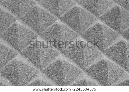 The pyramid structure of the professional acoustic foam. Grey background texture