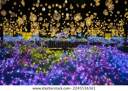Soft focus and blurred background of Bokeh lights garland or many small lantern festival, colorful flower, star lighting to decorated   lamp on  dark night  on Christmas day ,Happy new year holiday.