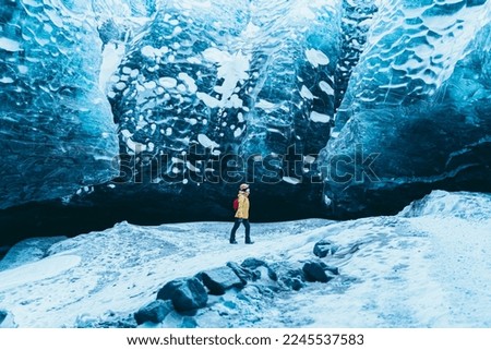 Man photographing a glacier with his smartphone.