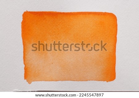 Orange watercolor rectangle on white canvas, top view Royalty-Free Stock Photo #2245547897