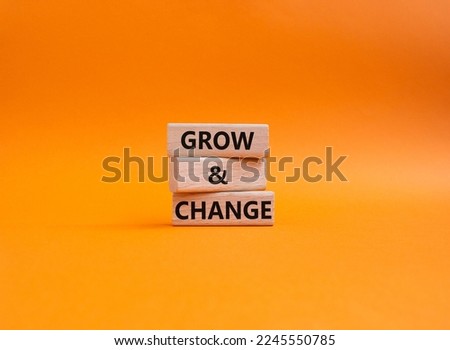 Grow and Change symbol. Concept word Grow and Change on wooden blocks. Beautiful orange background. Business and Grow and Change concept. Copy space