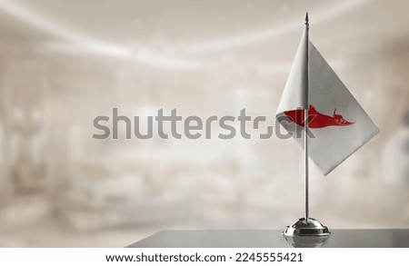 A small Easter Island flag on an abstract blurry background.