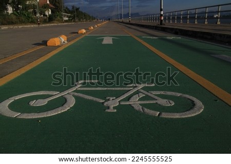 Cycling track with beautiful running paths and white bicycle symbols.