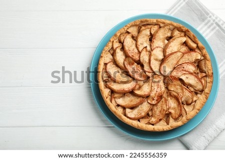 Delicious apple pie on white wooden table, top view. Space for text
