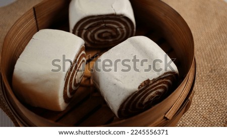 Soft and Hot Chinese chocolate steamed rolls, man tou, serving on traditional bamboo basket