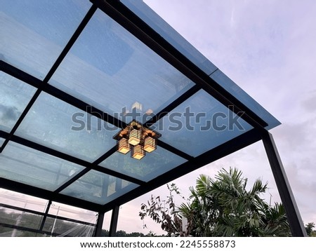 A translucent acrylic roof with black steel structure. Royalty-Free Stock Photo #2245558873