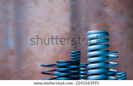 Different sizes of springs. Copper background. Copy space.