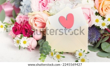 Love letter, envelope with heart and card on flower bouquet background
