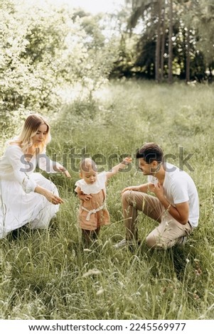 happy family resting playing with child outdoors. A perfect picture of a happy family. copy space